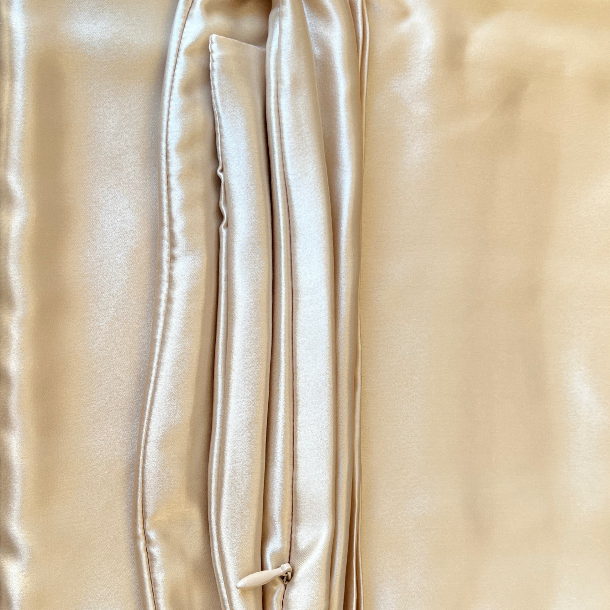 Gros plan sur la texture brillante de la soie de mûrier couleur champagne – Ade’Soie